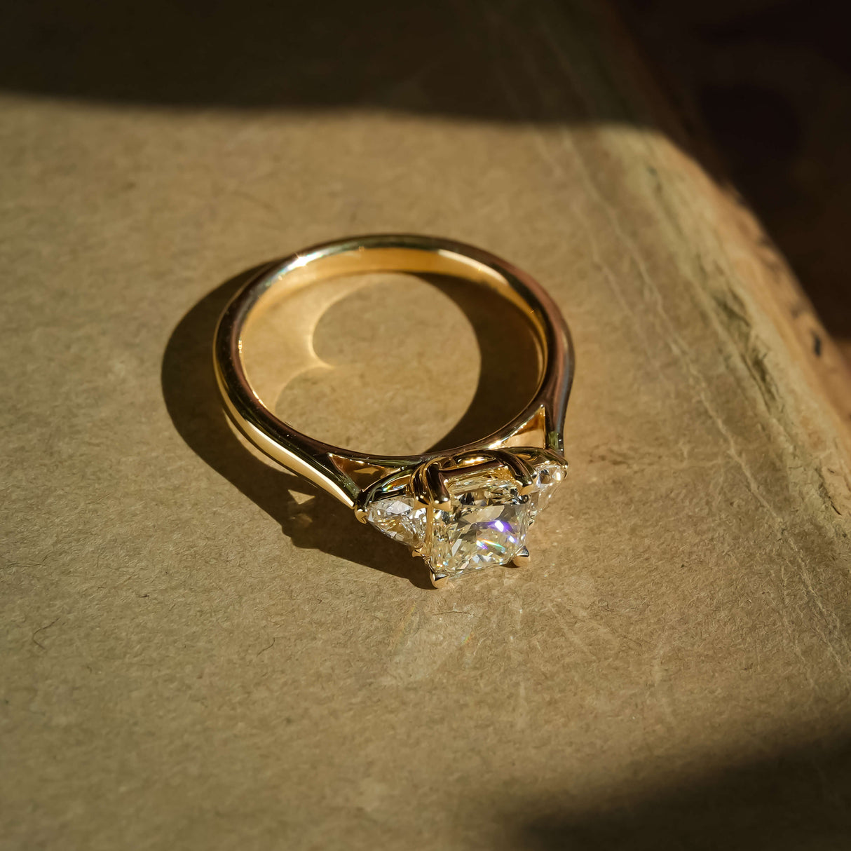 1.07ct diamond and side diamonds three stone engagement ring in yellow gold band