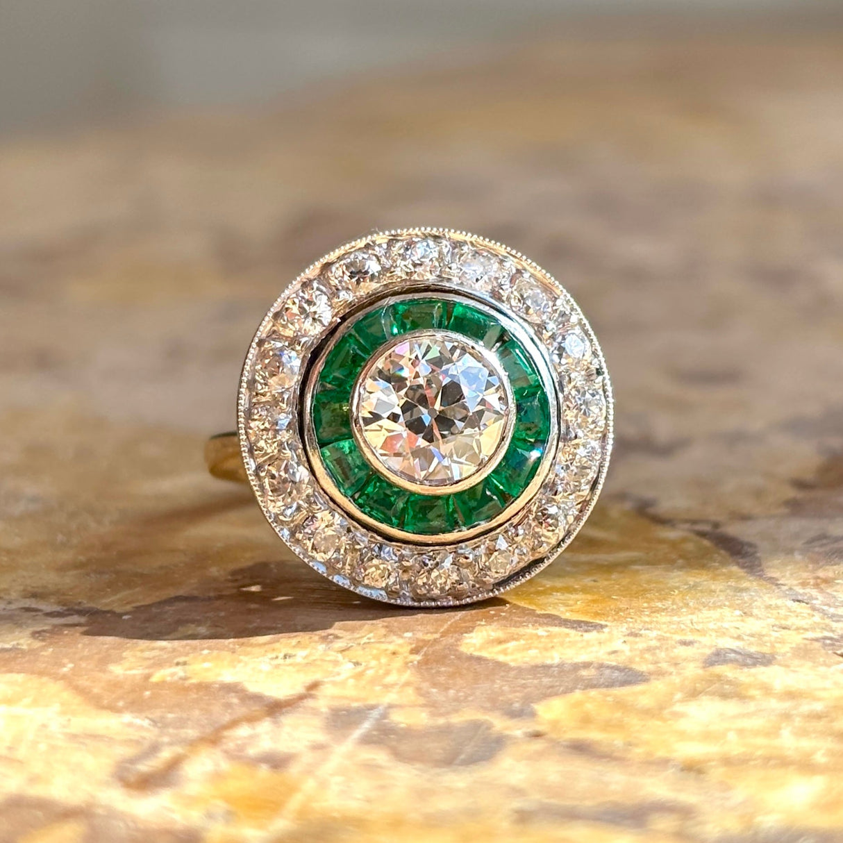Art Deco emerald & diamond target cluster ring, circa 1920s