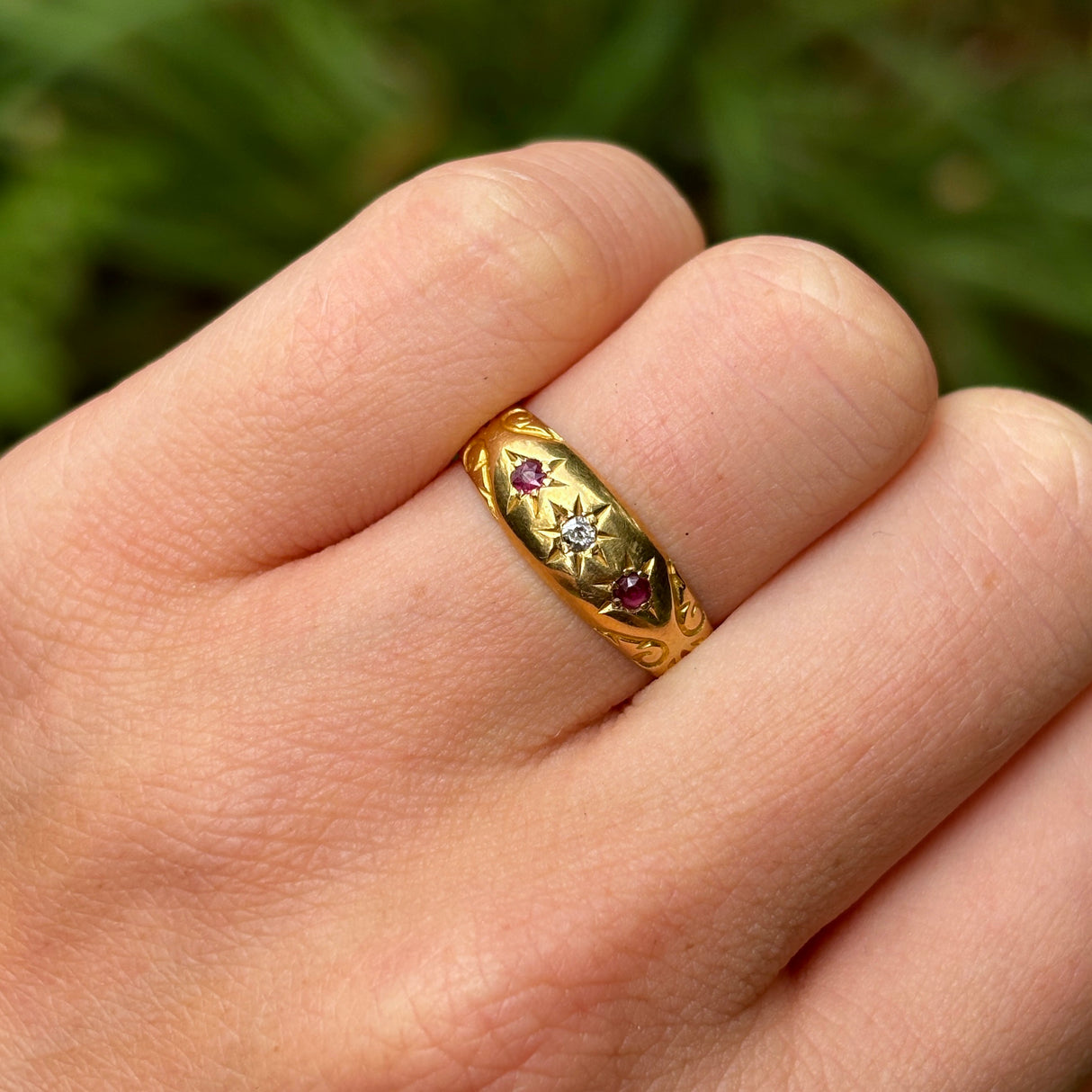 Antique, Edwardian ruby and diamond gypsy ring on hand.