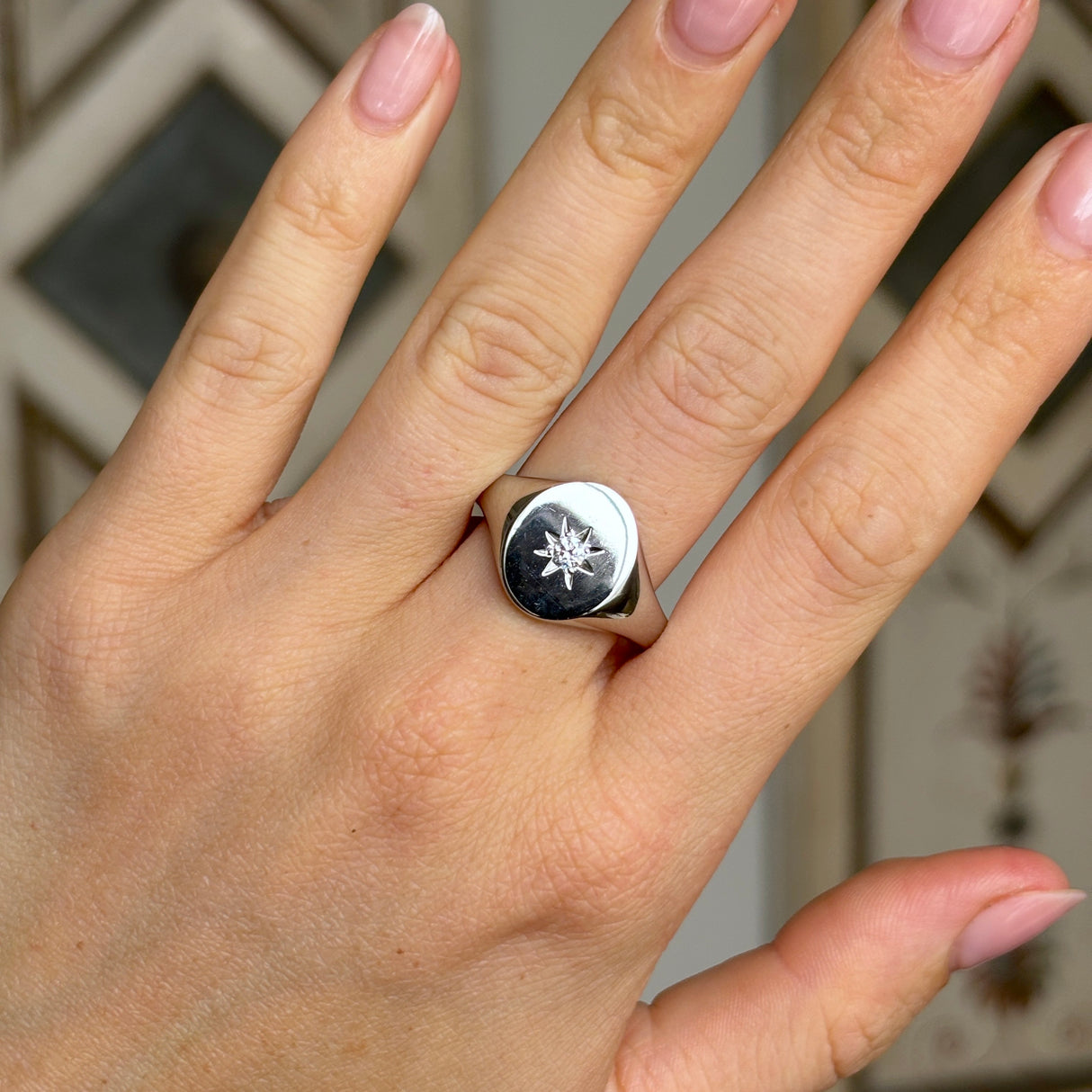 Vintage, 1980s diamond signet ring worn on hand.