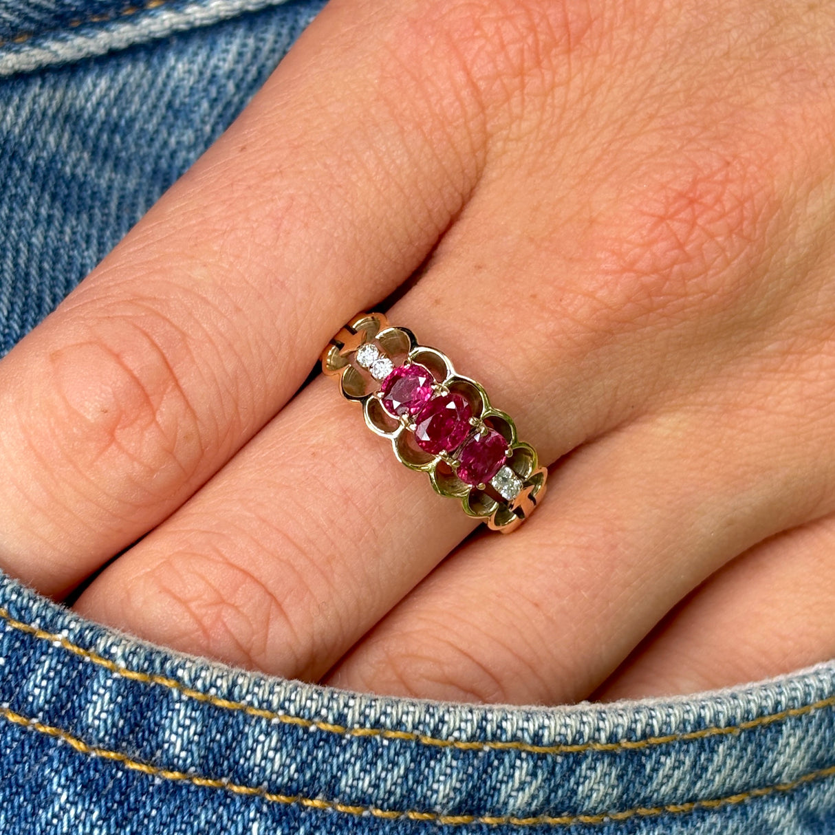 Vintage, 1980s ruby and diamond three-stone ring worn on hand