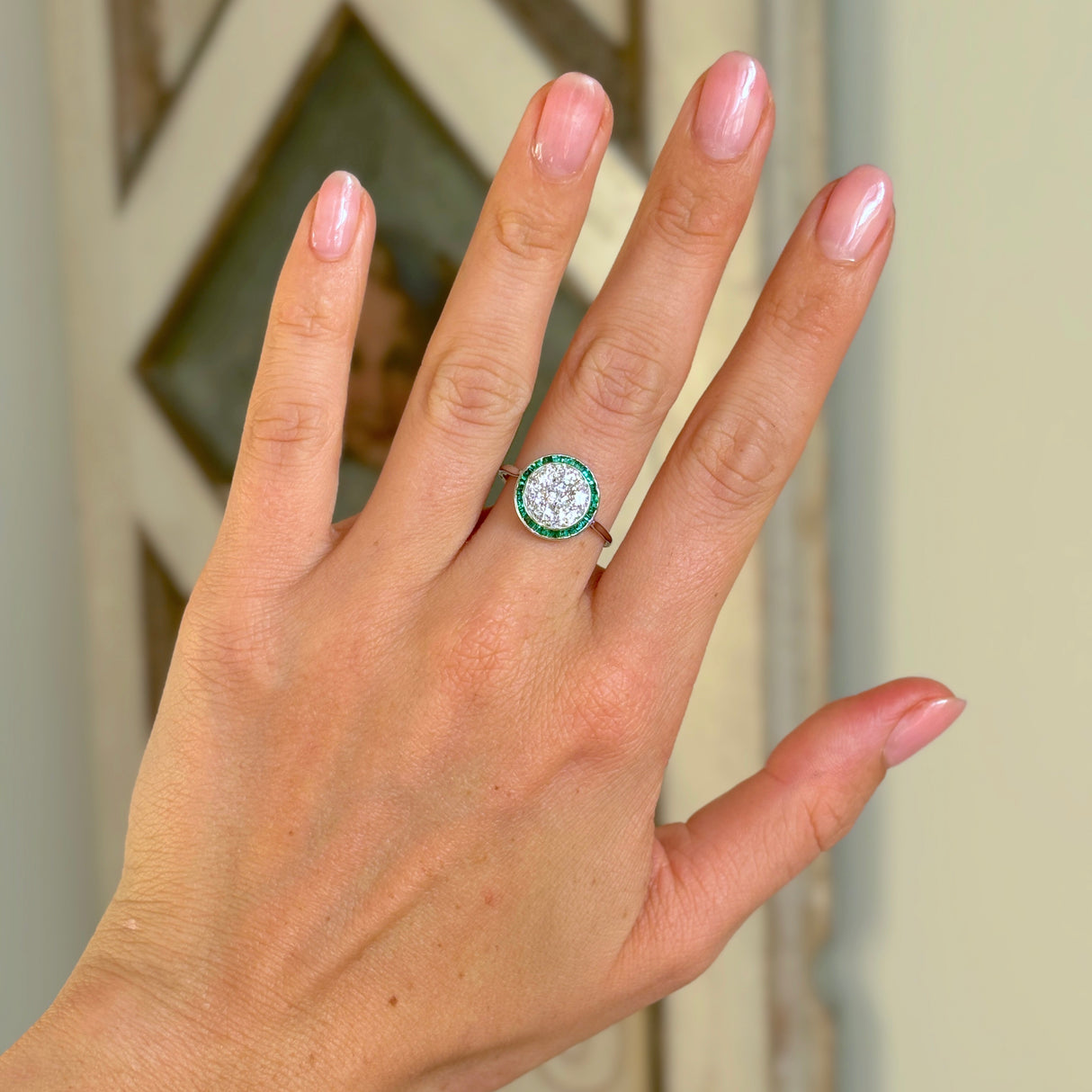 Vintage, Art Deco emerald & diamond target cluster ring worn on hand.