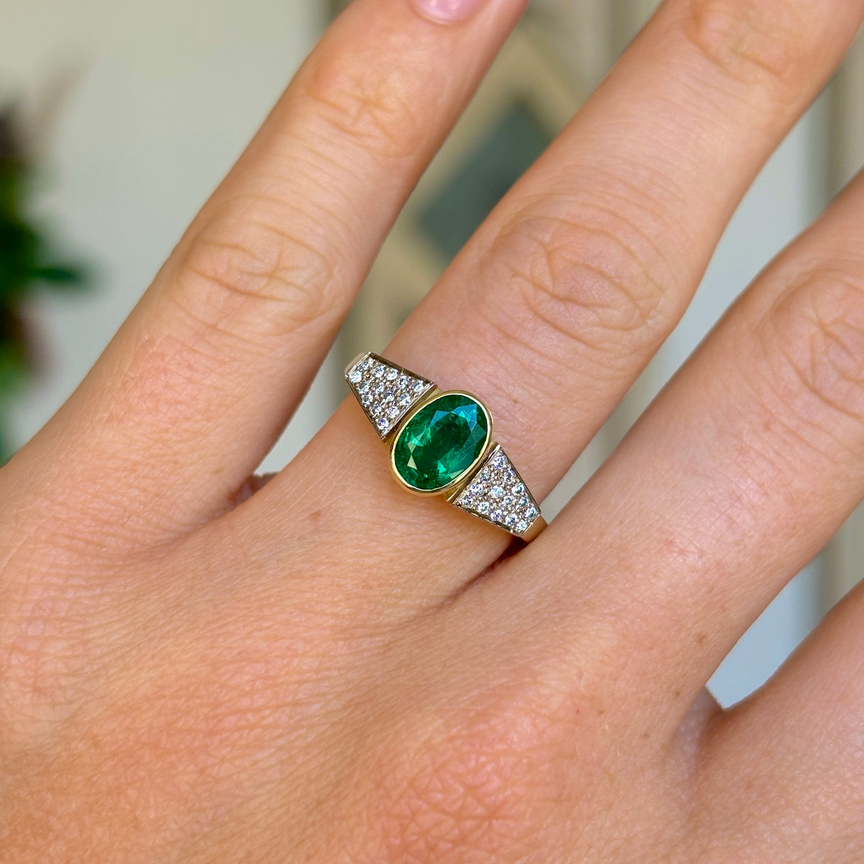 Vintage, 1970s inspired emerald & diamond ring worn on hand.