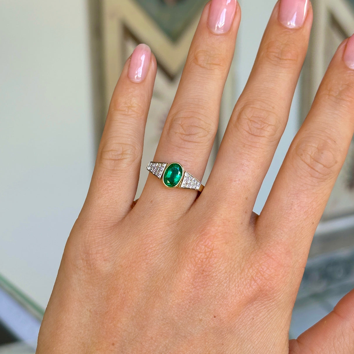 Vintage, 1970s inspired emerald & diamond ring worn on hand.