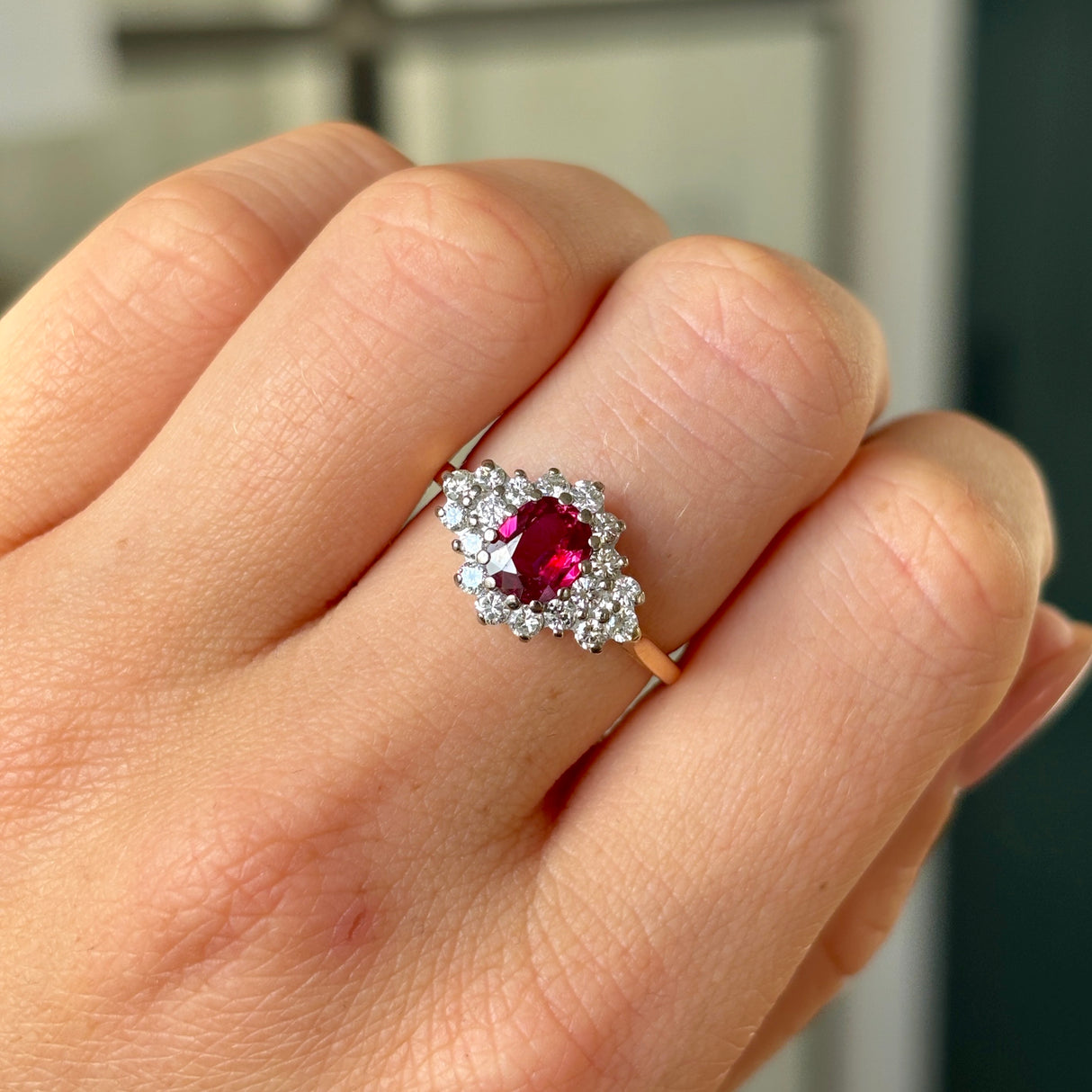Vintage, 1970s ruby & diamond cluster ring worn on hand.