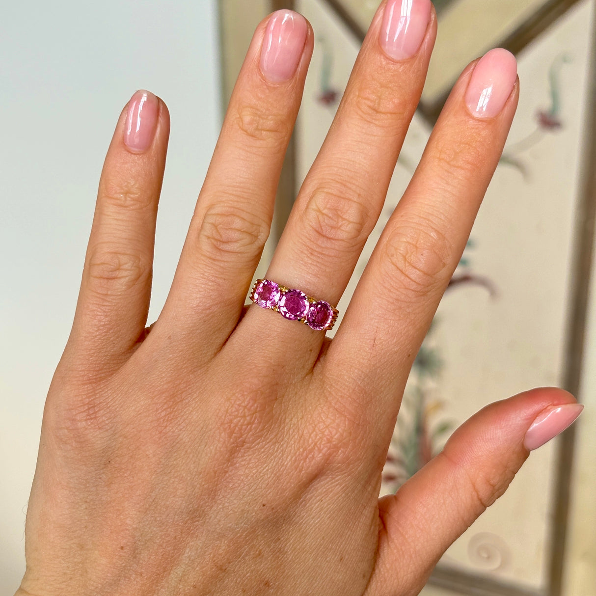 2077-Vintage, 1930s pink sapphire three-stone ring on hand