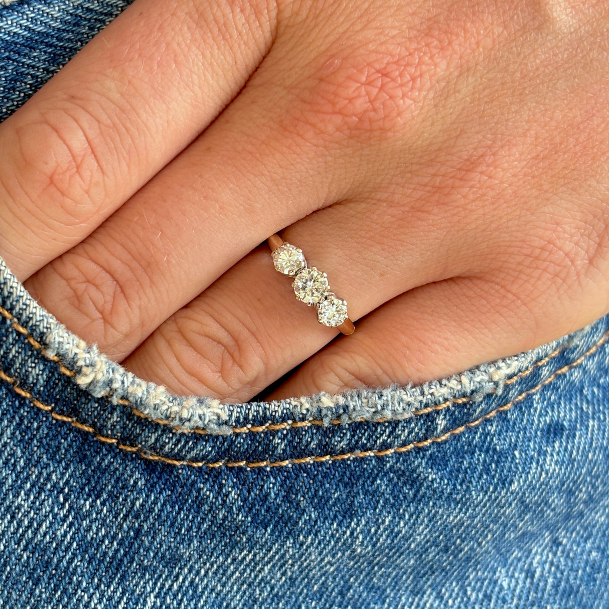 Vintage, 1970s three-stone diamond ring worn on hand.