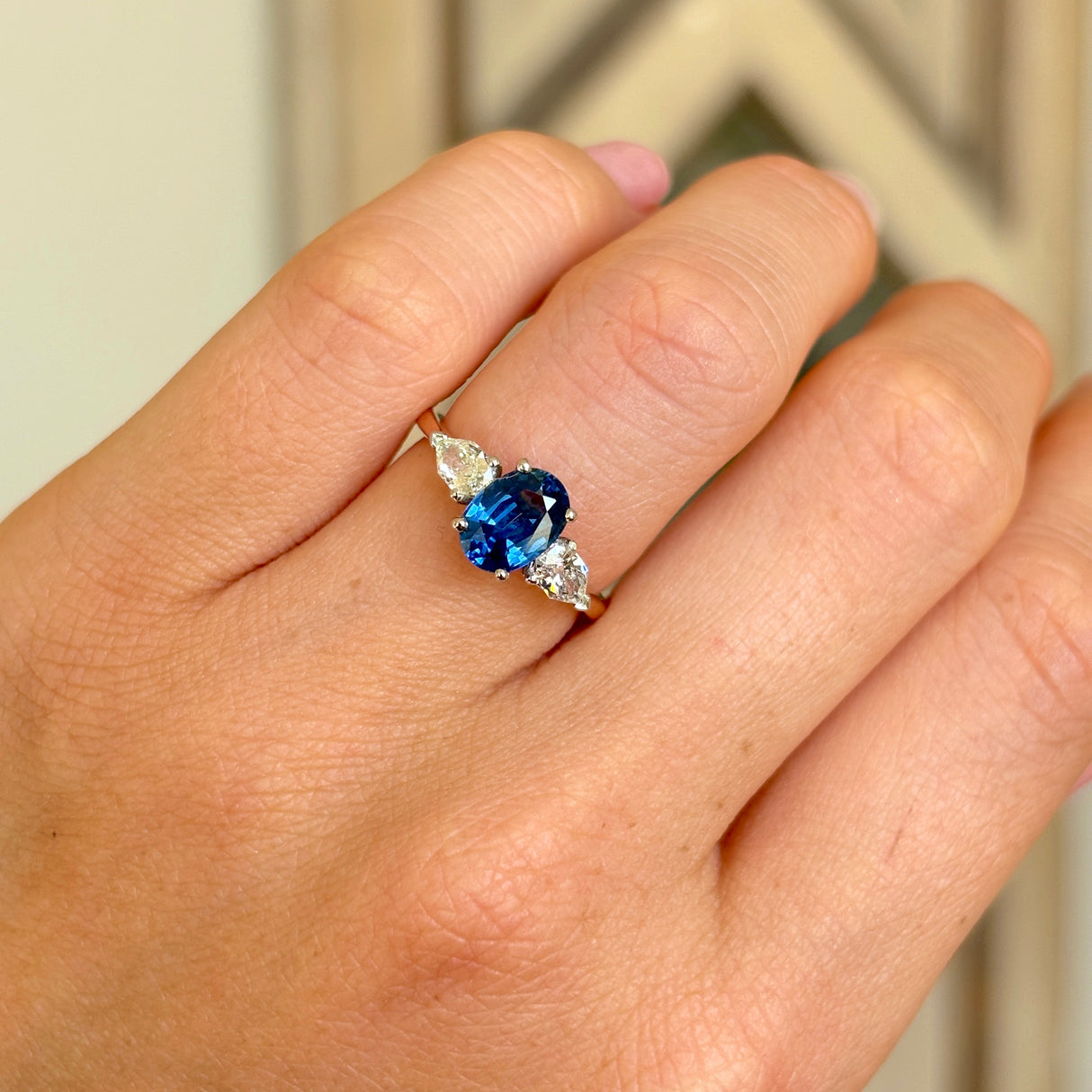 Vintage, sapphire & diamond three-stone ring worn on hand.