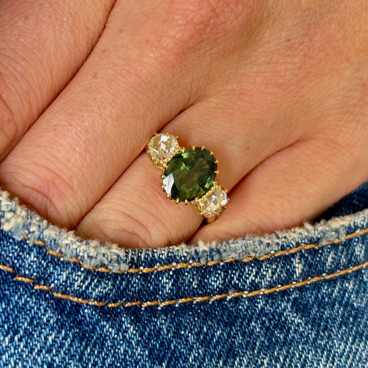 A ring set with a 1950s green sapphire and 18th century rose-cut diamonds