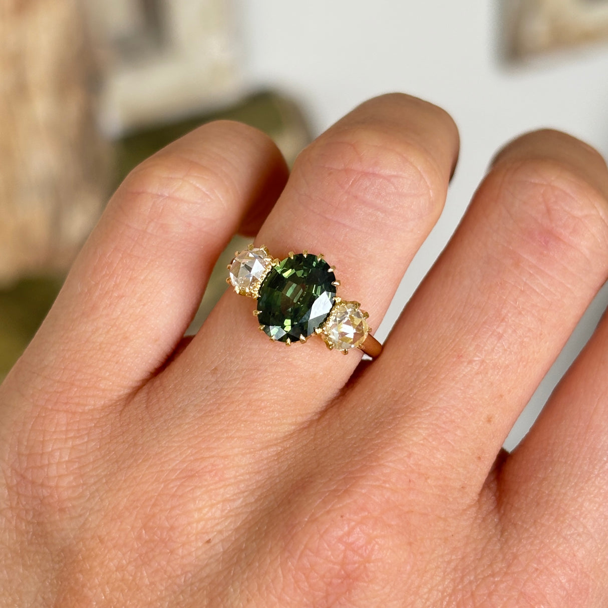 A ring set with a 1950s green sapphire and 18th century rose-cut diamonds