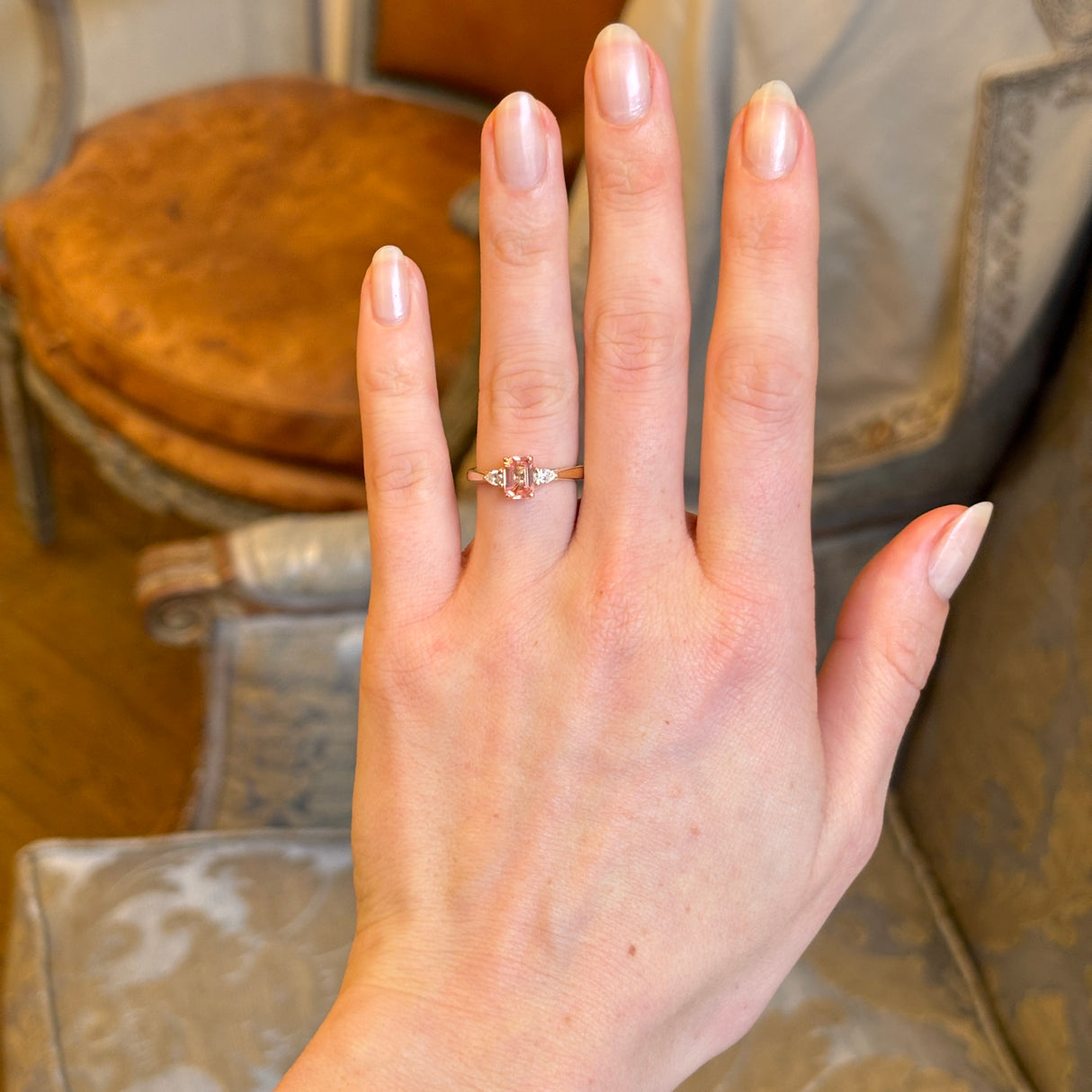 Pink sapphire and diamond three-stone engagement ring