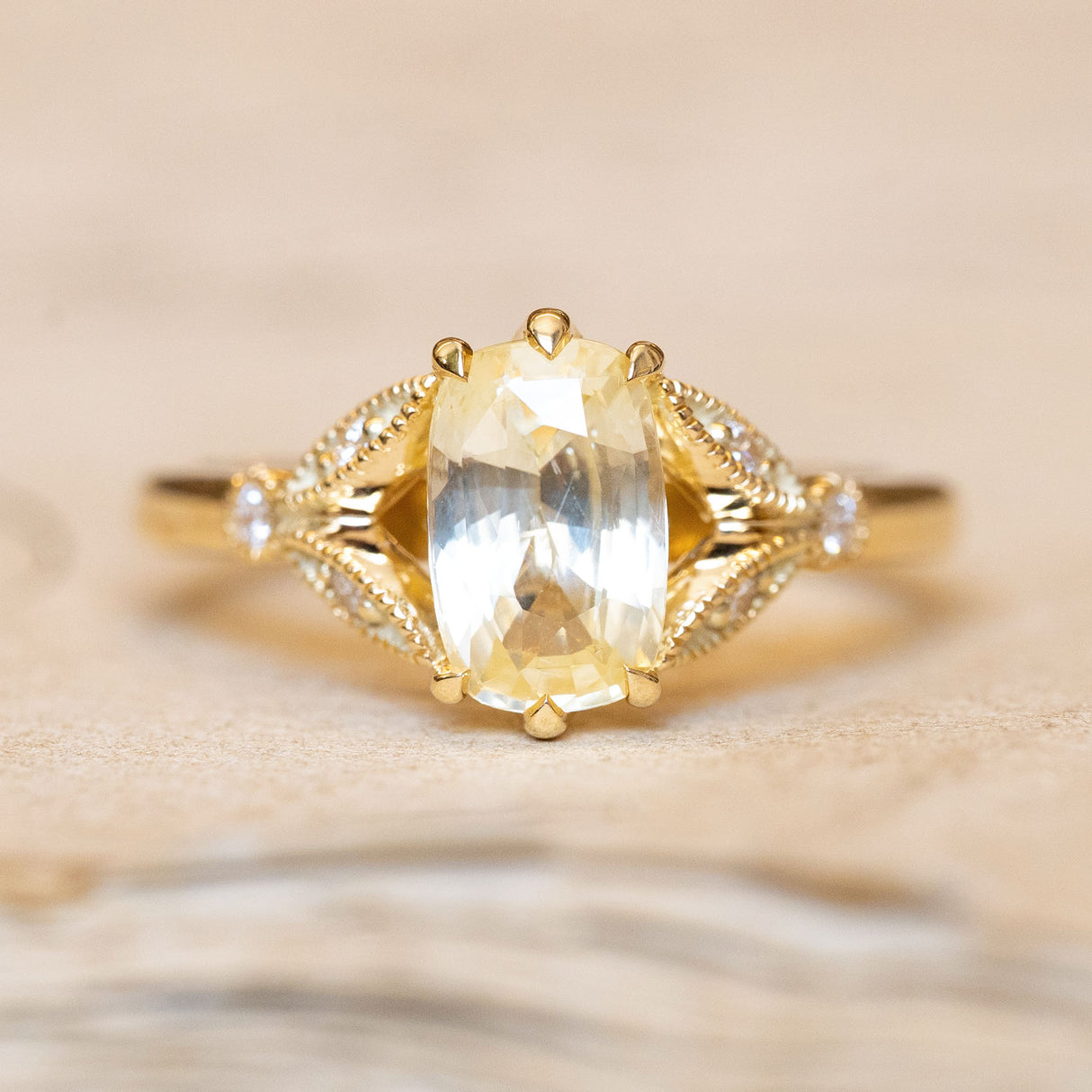 Antique-inspired yellow cushion cut sapphire & diamond engagement ring in 14ct yellow gold.
