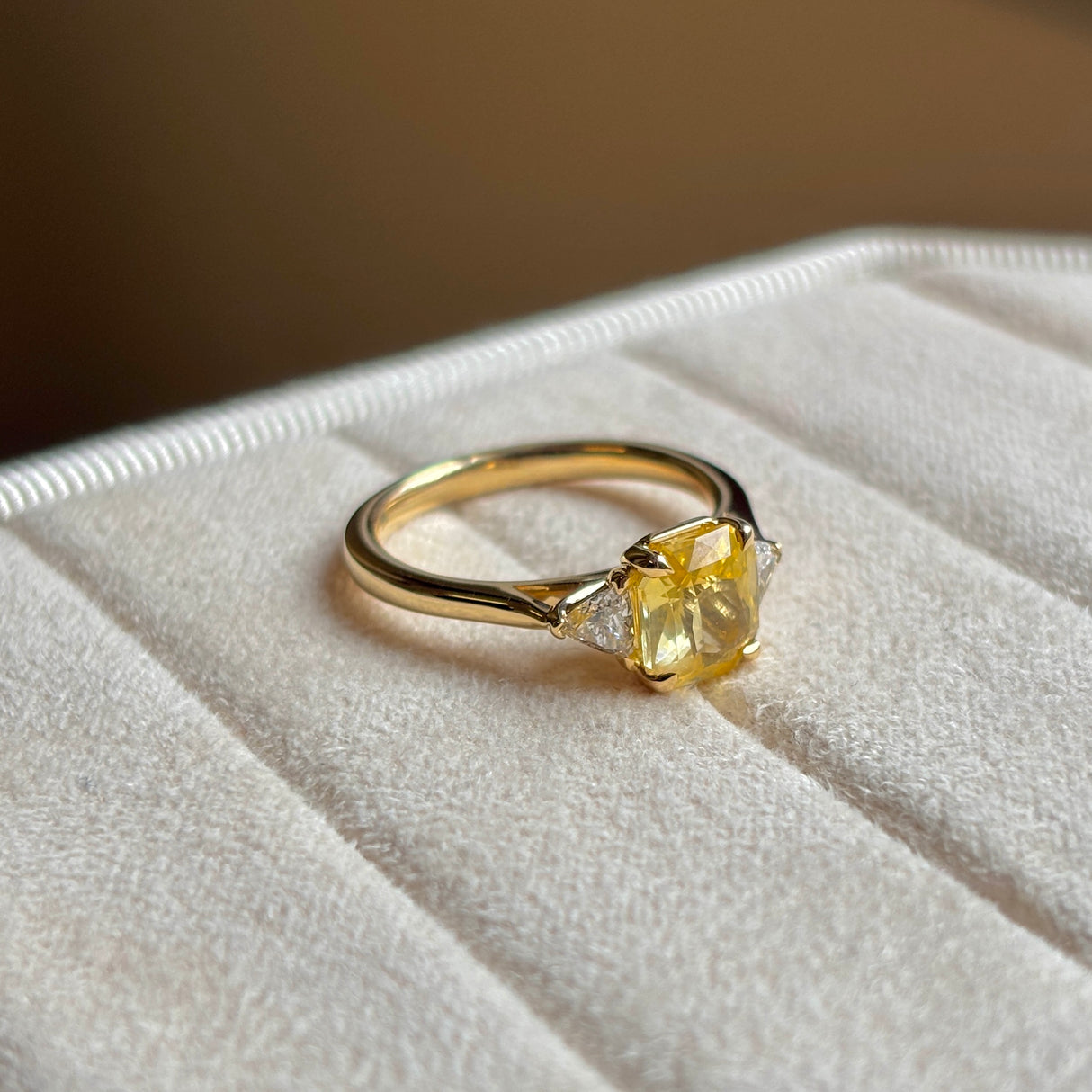 Yellow sapphire and diamond three-stone ring