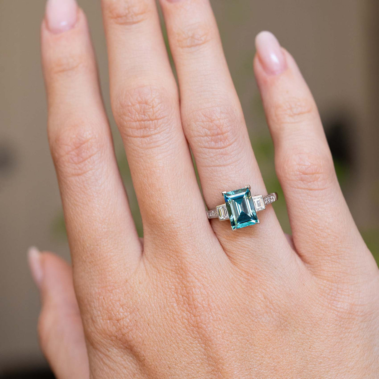 An antique Art Deco 1920s zircon and diamond ring worn on the hand.