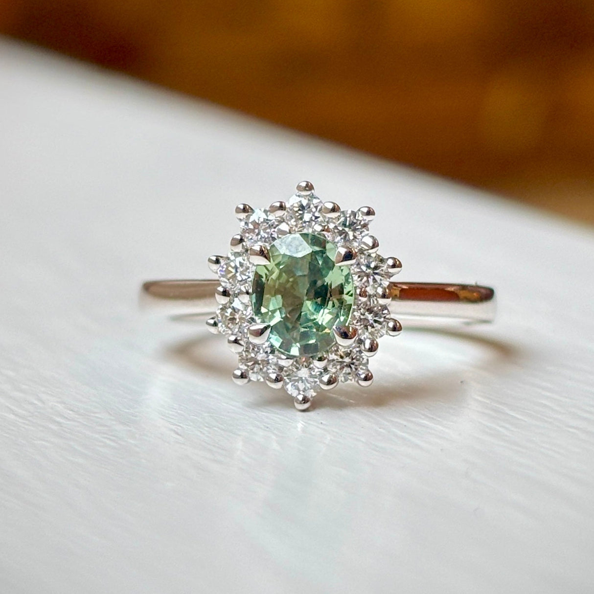 Oval-cut green sapphire & diamond cluster ring