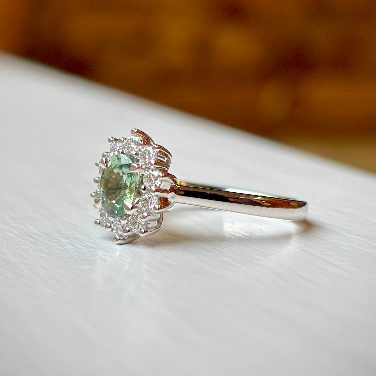 Oval-cut green sapphire & diamond cluster ring