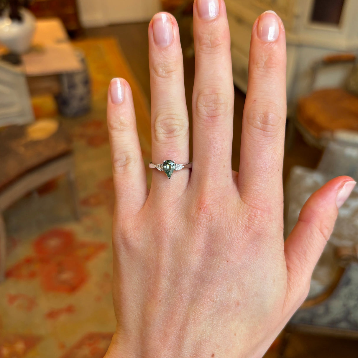 Pear-cut teal sapphire & diamond three-stone engagement ring