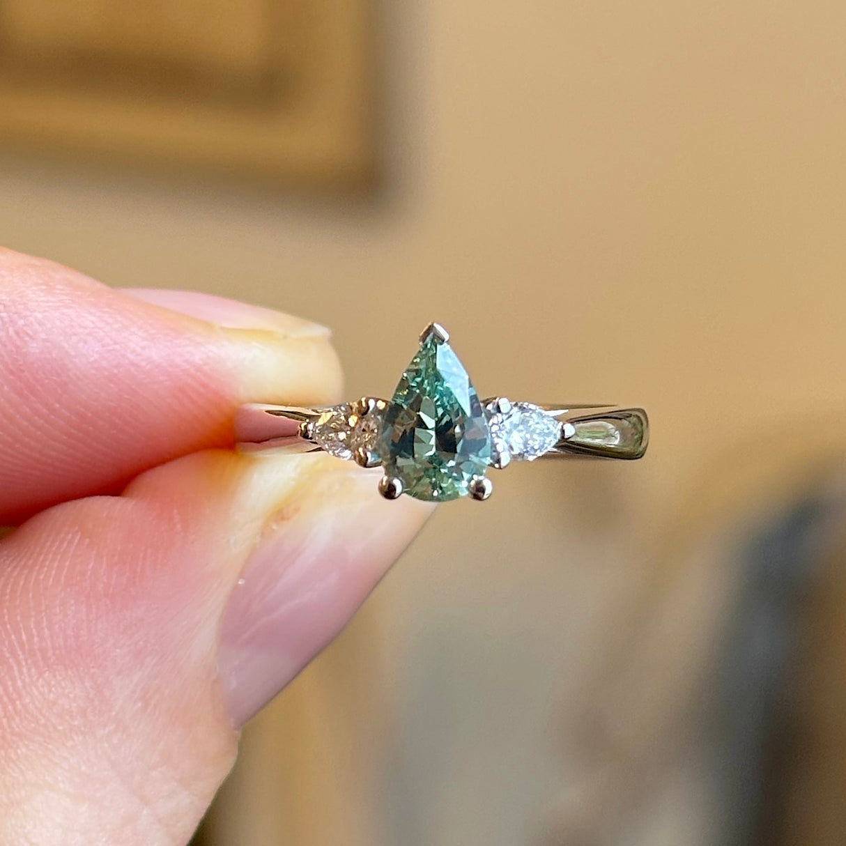 Pear-cut teal sapphire & diamond three-stone engagement ring
