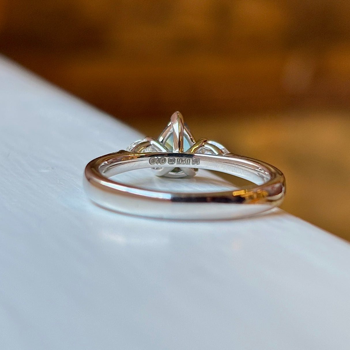 Pear-cut teal sapphire & diamond three-stone engagement ring