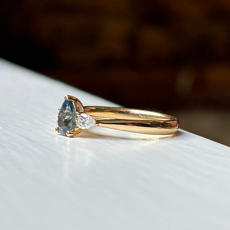 Pear-cut teal sapphire & diamond three-stone ring
