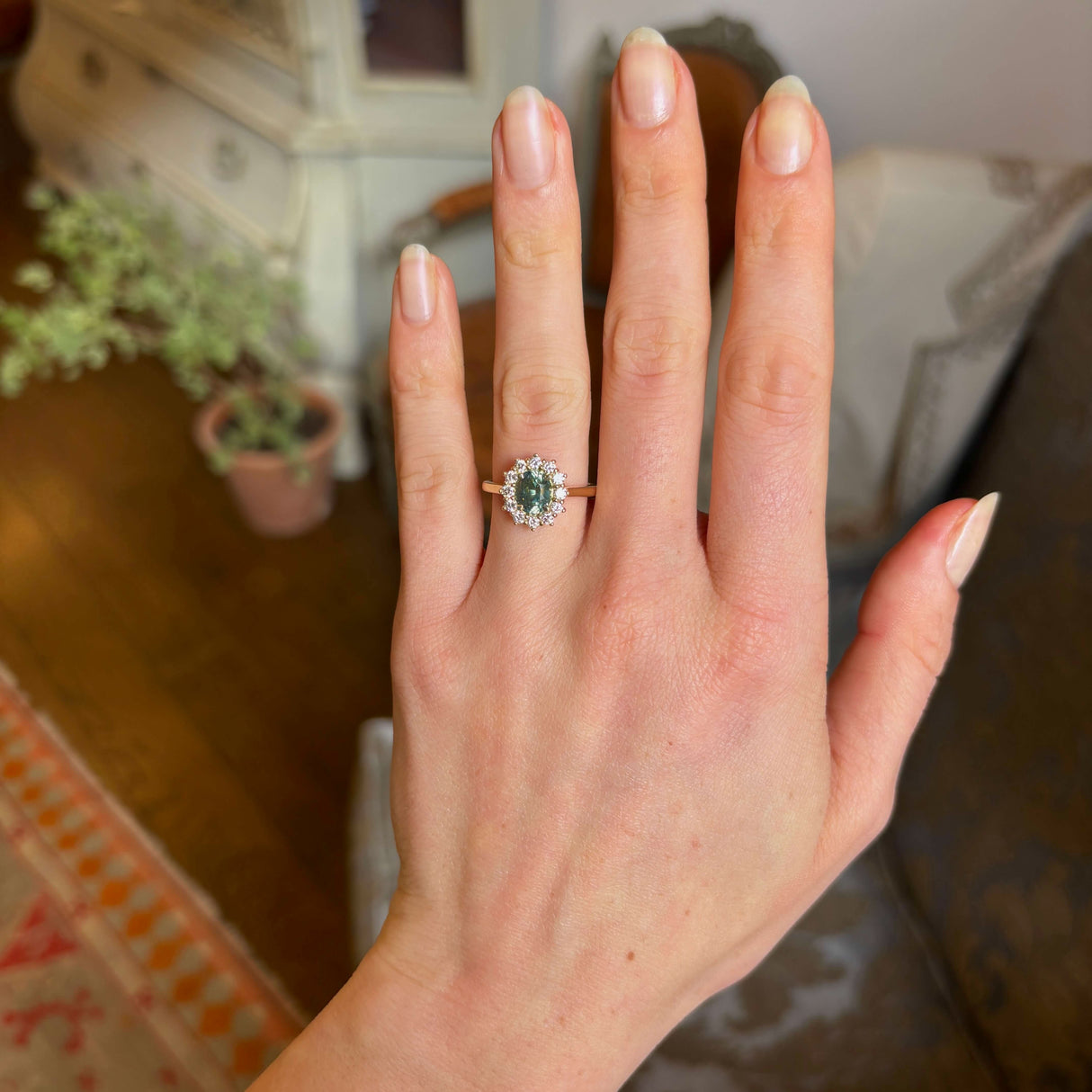 Green sapphire and diamond cluster engagement ring
