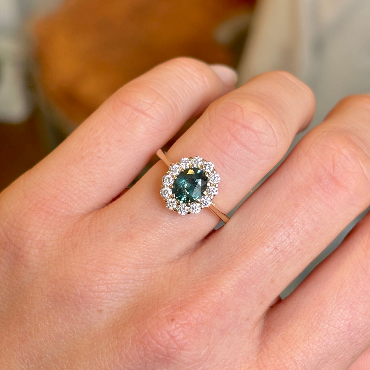 Green sapphire and diamond cluster engagement ring