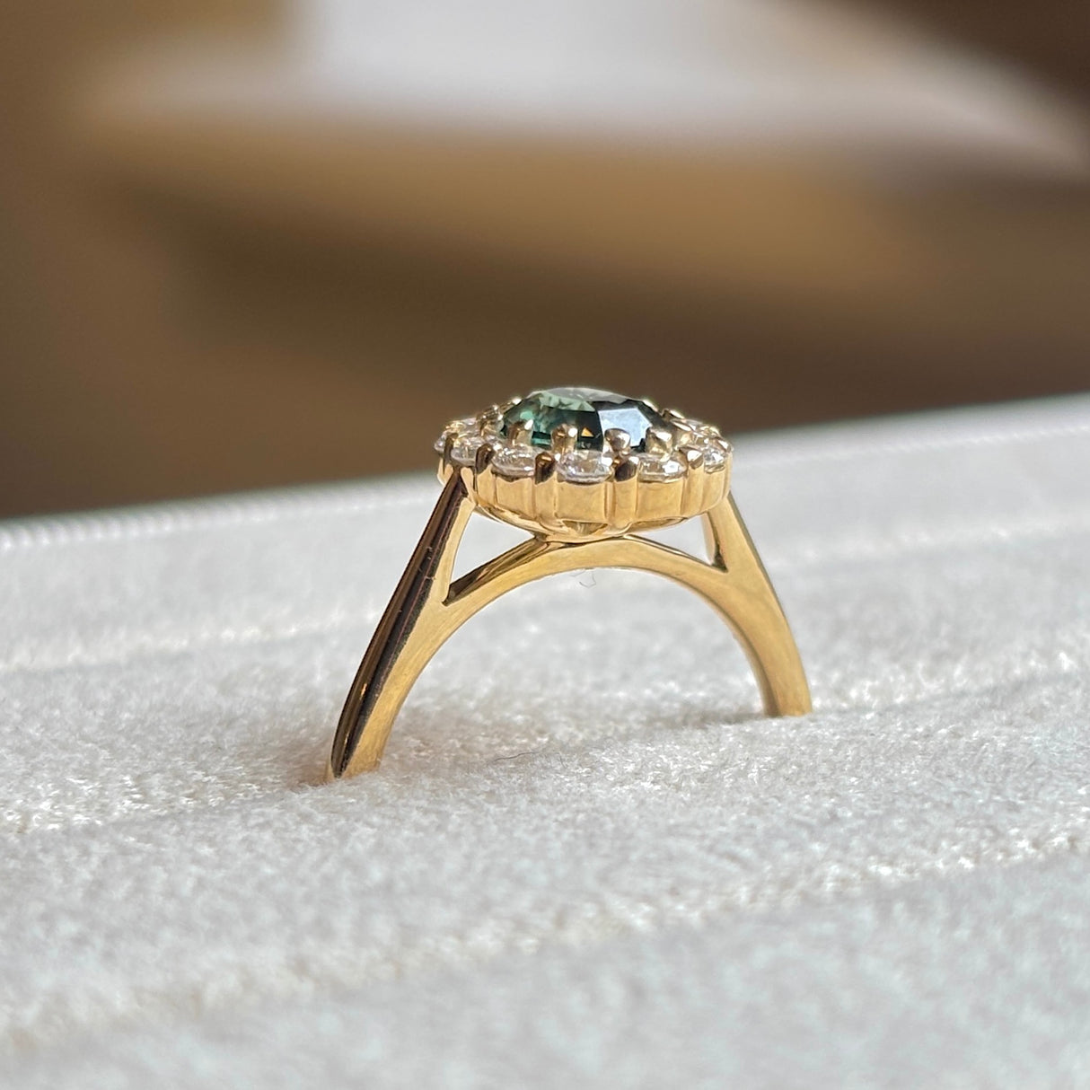Green sapphire and diamond cluster engagement ring