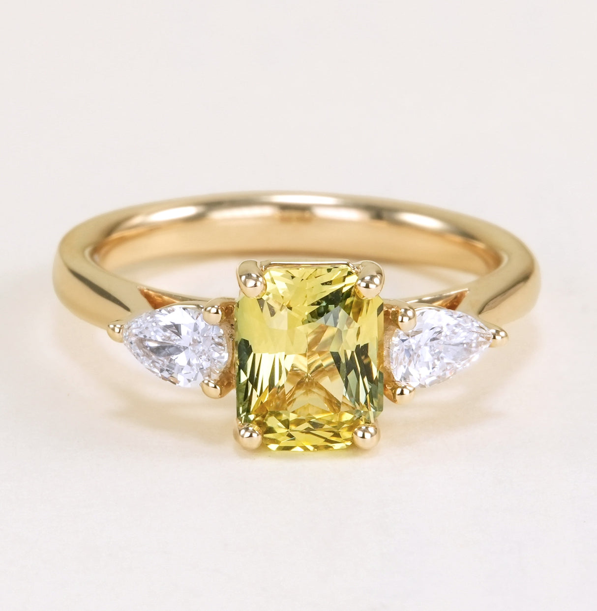 Emerald-cut yellow sapphire and diamond three-stone ring