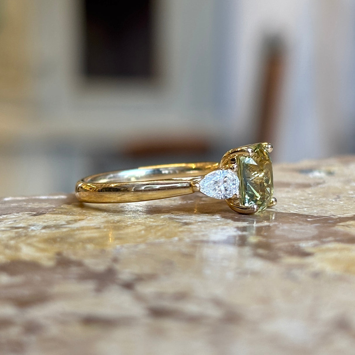 Emerald-cut yellow sapphire and diamond three-stone ring
