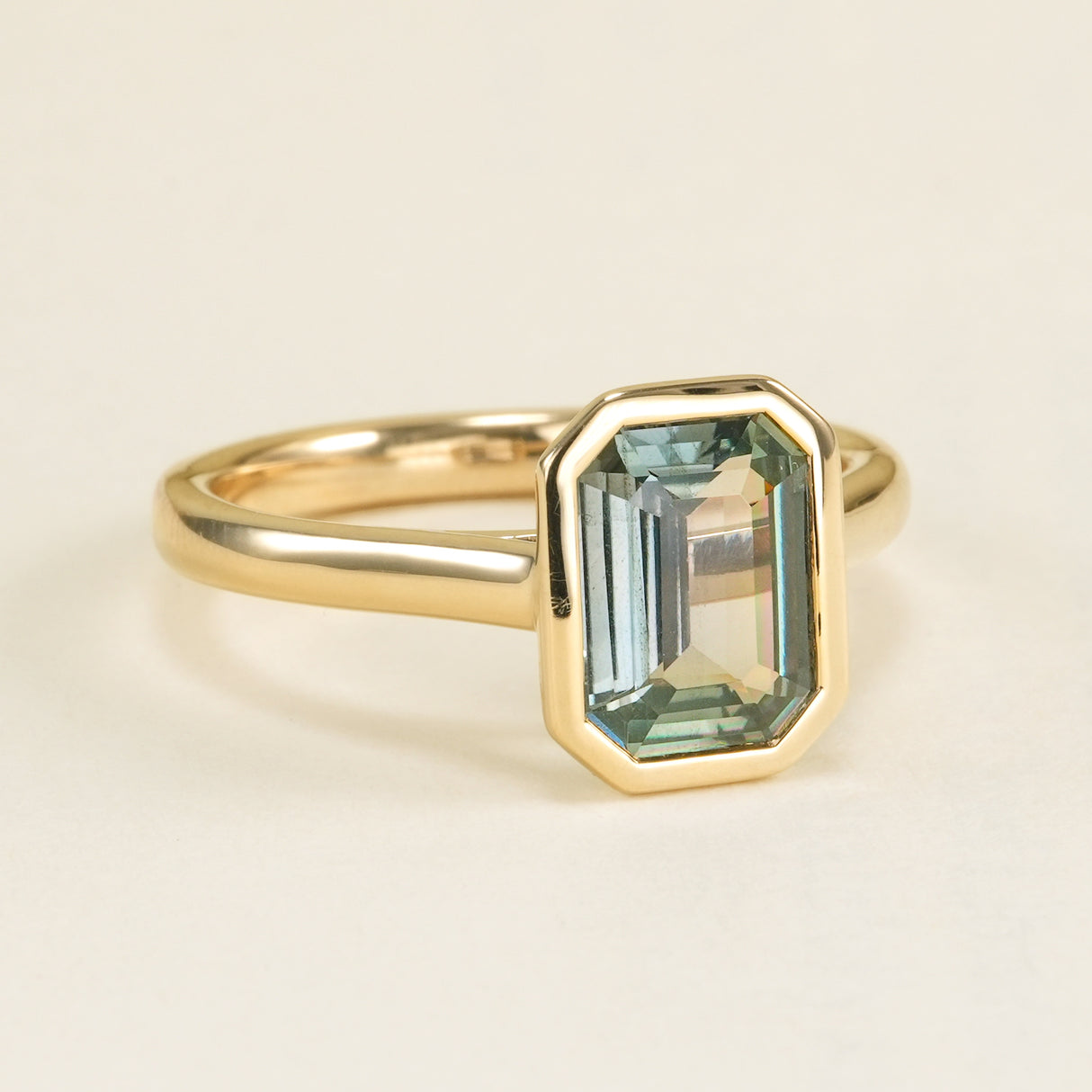 Emerald-cut teal sapphire single-stone ring