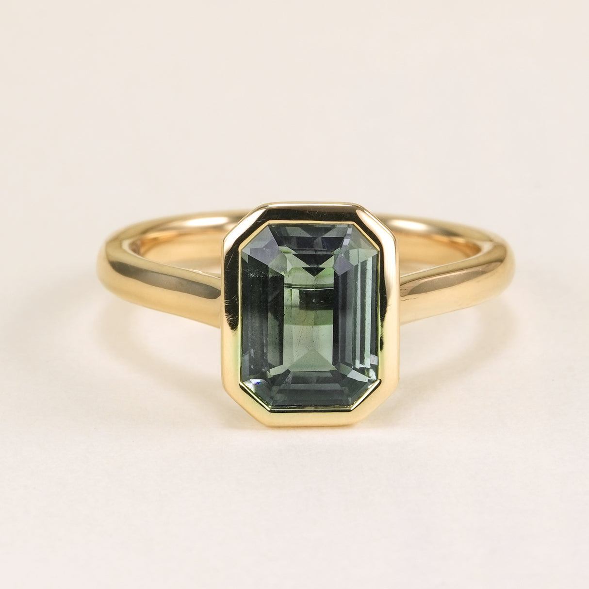 Emerald-cut teal sapphire single-stone ring