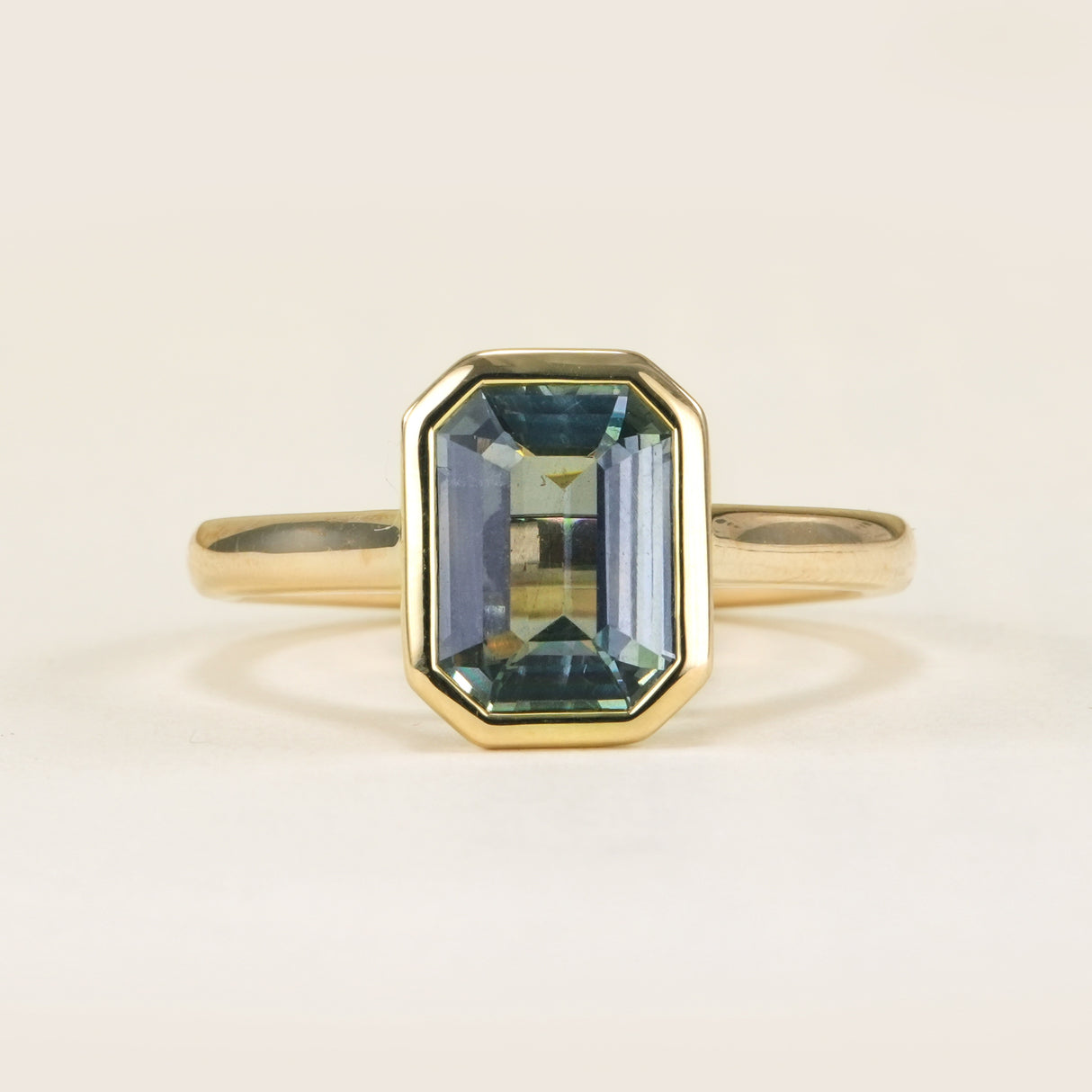 Emerald-cut teal sapphire single-stone ring