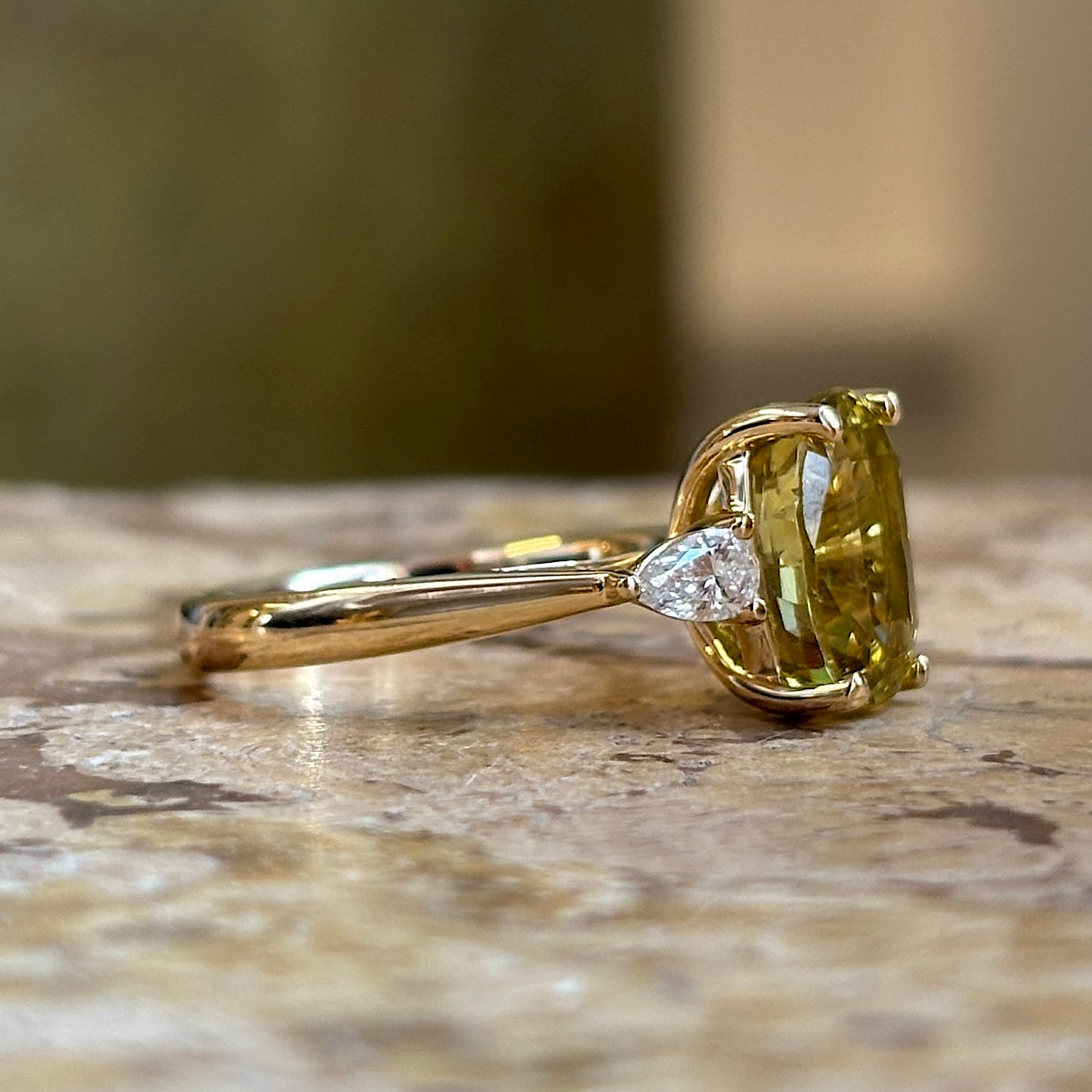 Chrysoberyl and pear-cut diamond three-stone ring