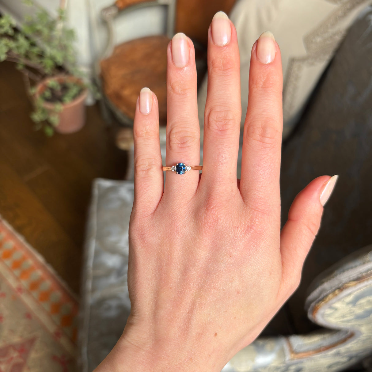 Blue sapphire and diamond three-stone engagement ring