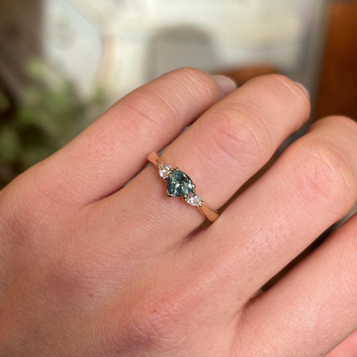 Green sapphire and diamond three-stone engagement ring