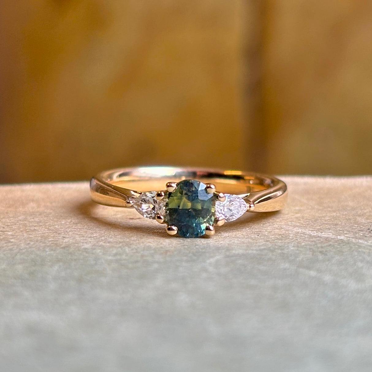 Teal sapphire and diamond three-stone engagement ring