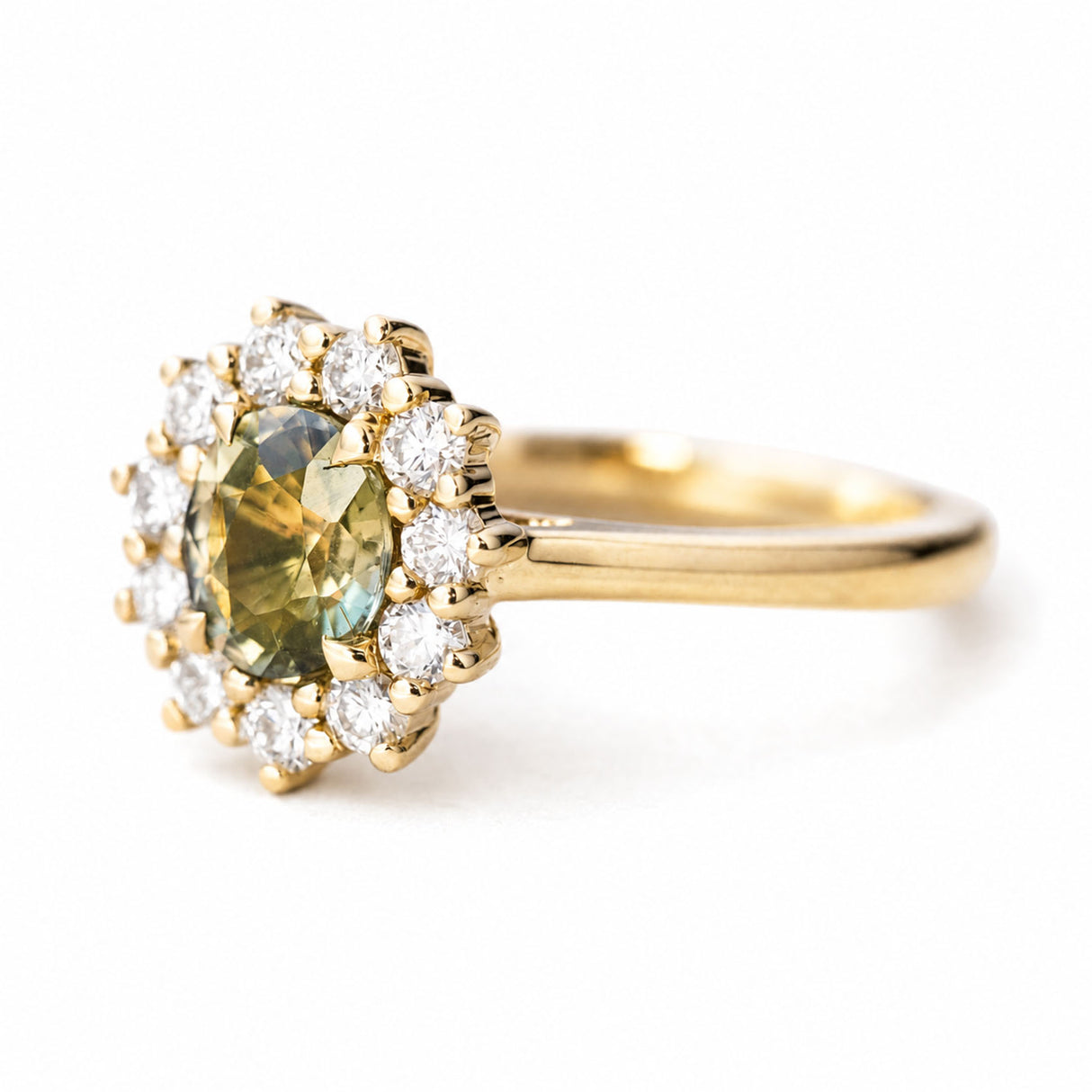 A yellow gold engagement ring featuring an oval green sapphire and a brilliant-cut diamond halo.