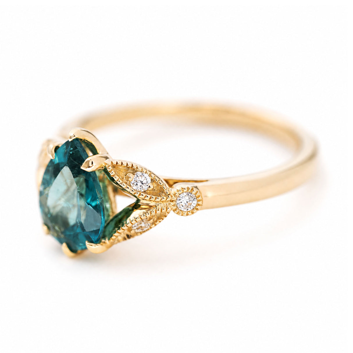 Angled view of a pear-cut teal tourmaline ring with diamond-set shoulders