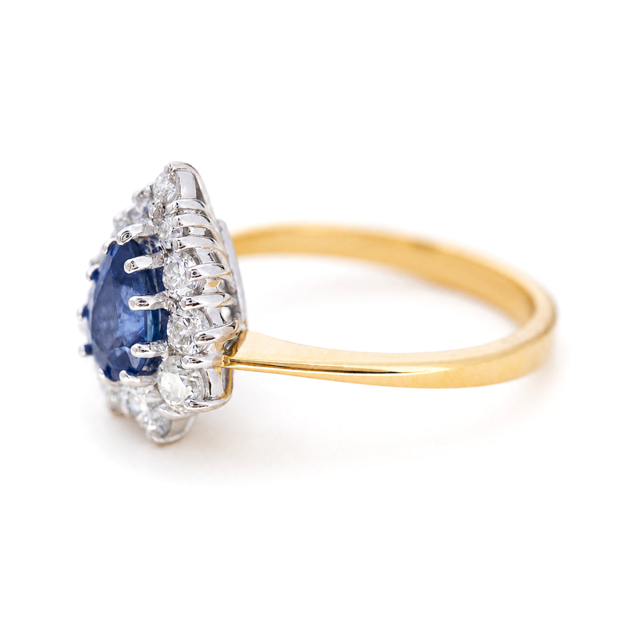 A Side view of a pear-cut sapphire and diamond cluster ring