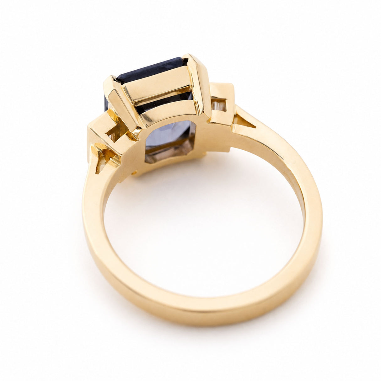 A 14ct yellow gold ring with a geometric setting holding a smokey blue spinel.
