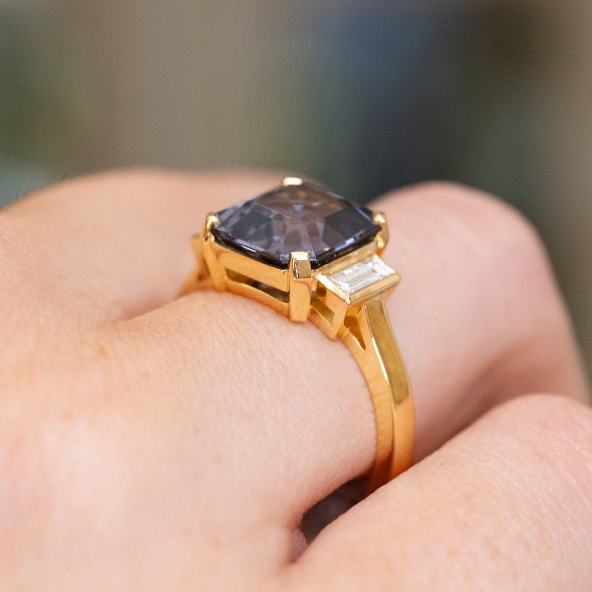 Side profile of a vintage-inspired blue spinel and diamond ring