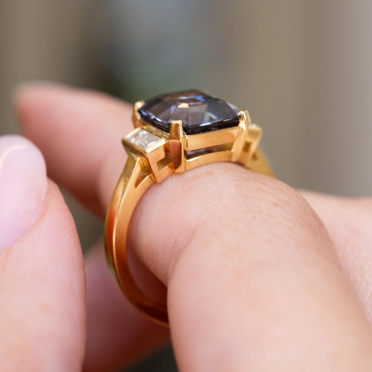 Side view showing the raised blue spinel setting and yellow gold band