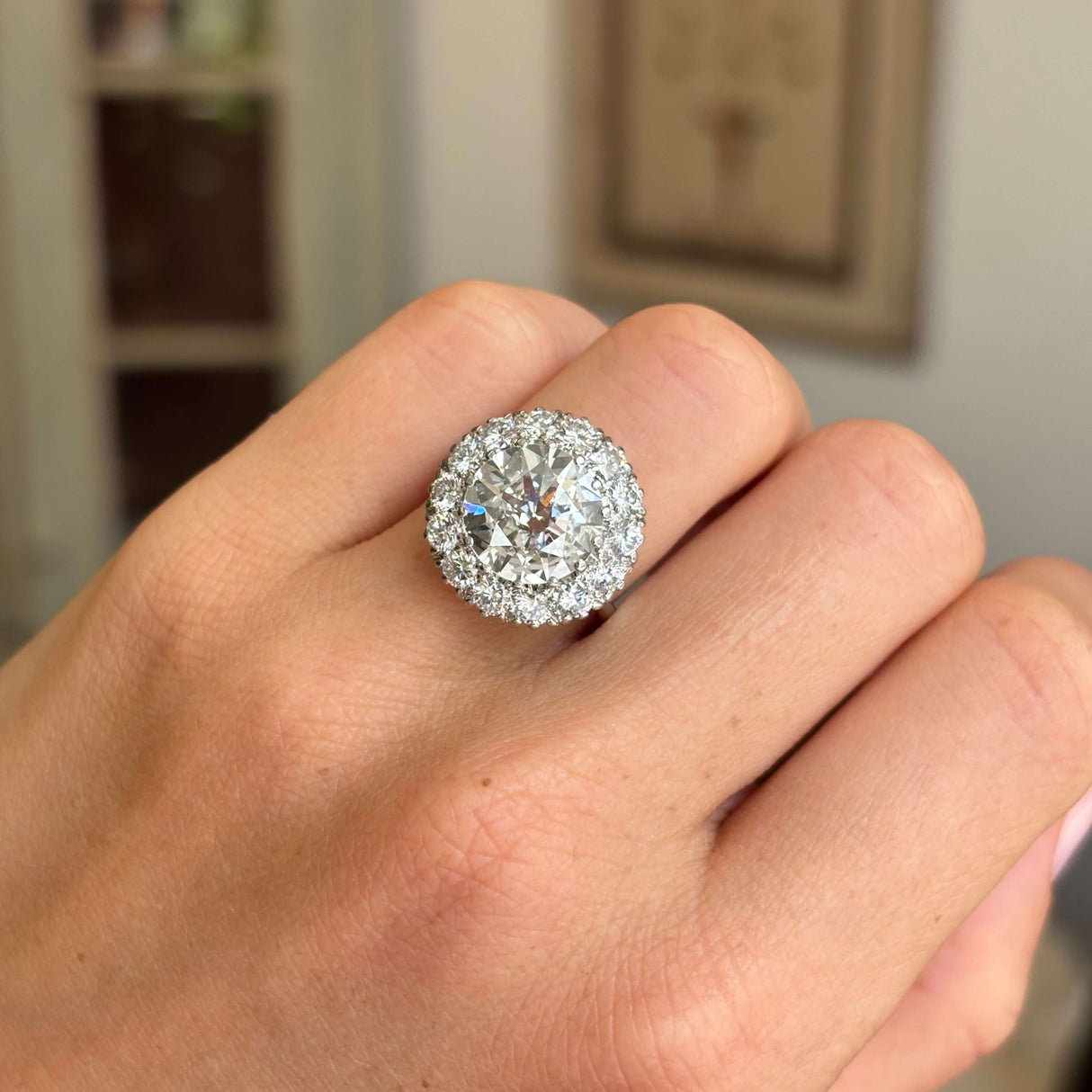 Close-up of a vintage 1950s platinum diamond cluster engagement ring, highlighting approximately 4 carats of brilliant diamonds.