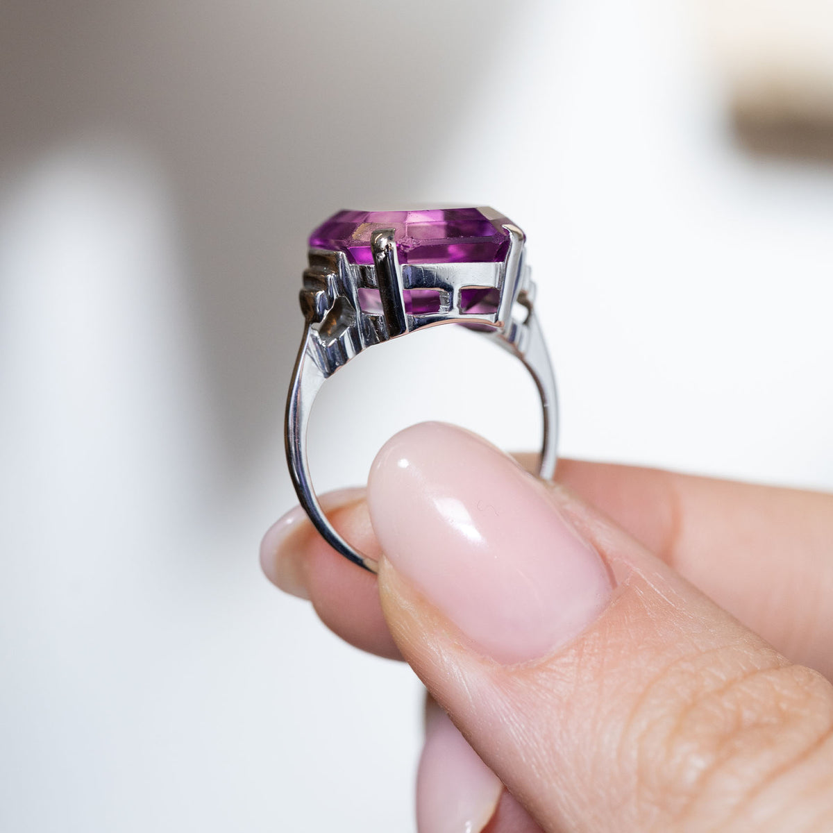 Side profile of the Art Deco cocktail ring, highlighting the open gallery, geometric shoulder details and polished white gold band.