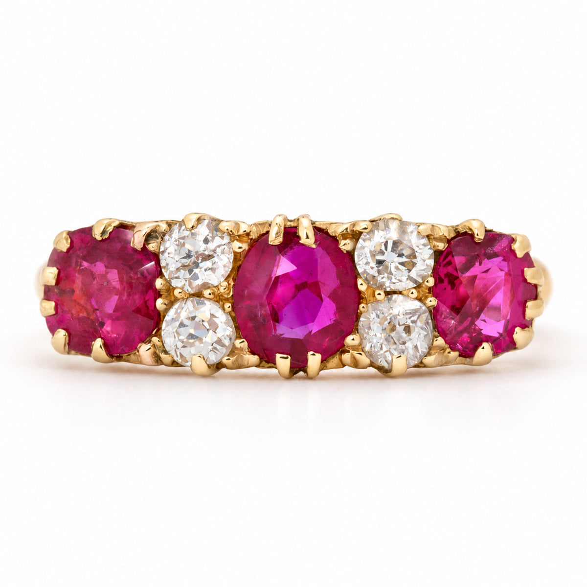 Antique Edwardian Burmese ruby and old-cut diamond five-stone engagement ring in yellow gold, with alternating vivid rubies and bright diamonds.