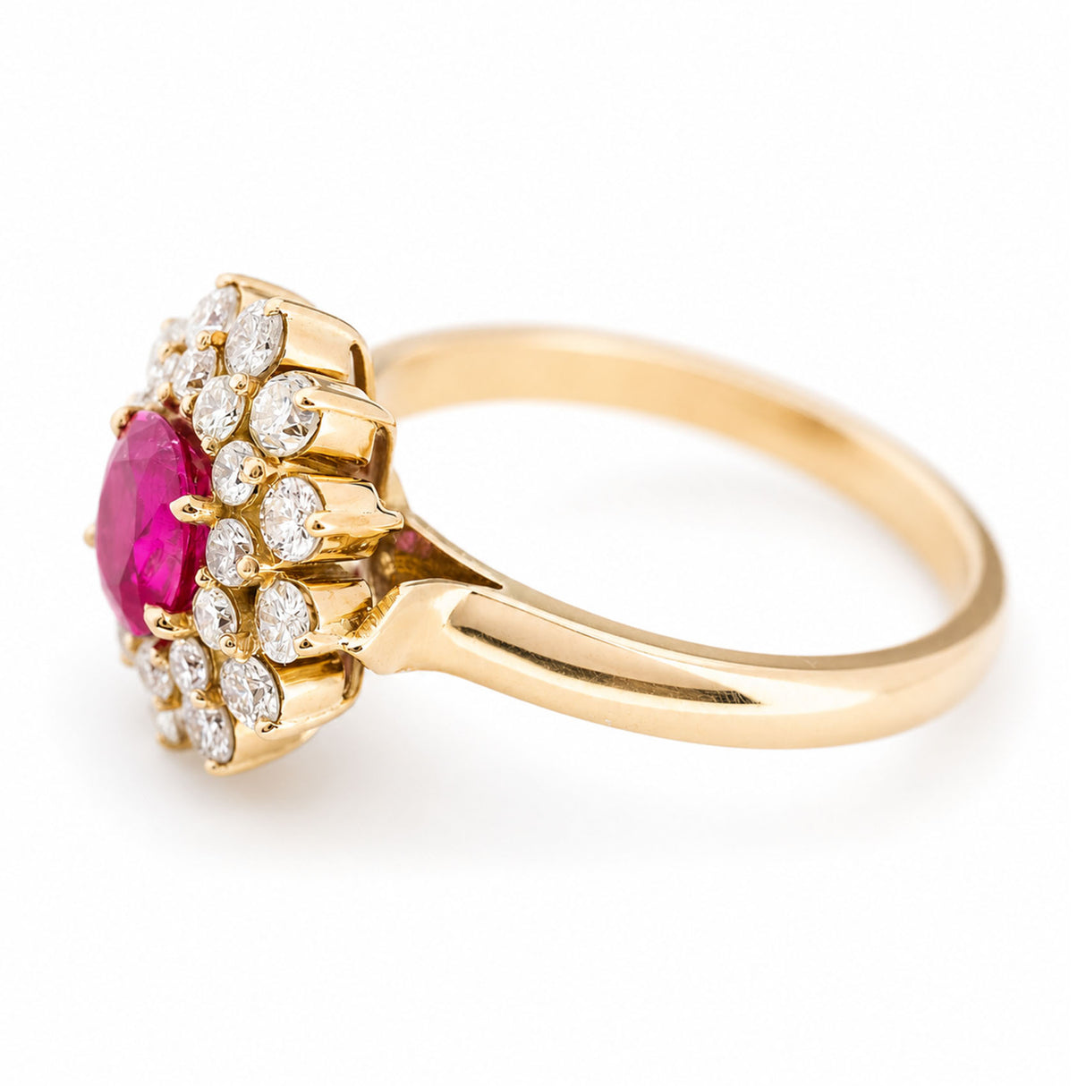 A vintage yellow gold ring featuring a round ruby centre stone surrounded by a double halo of diamonds, shown on a plain white background.