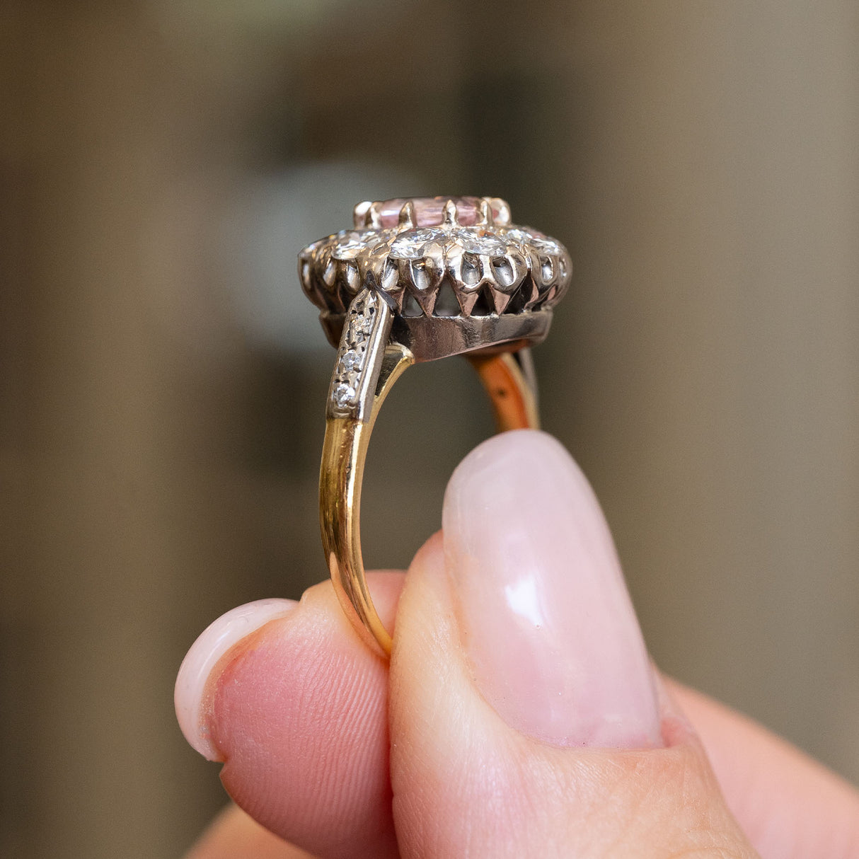 Vintage orange-pink sapphire and diamond cluster ring showing the open gallery beneath the sapphire and diamond cluster.