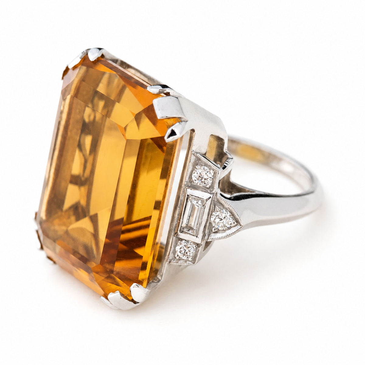 A large antique cocktail ring from the Art Deco era featuring a 20ct orange emerald-cut citrine set in platinum.