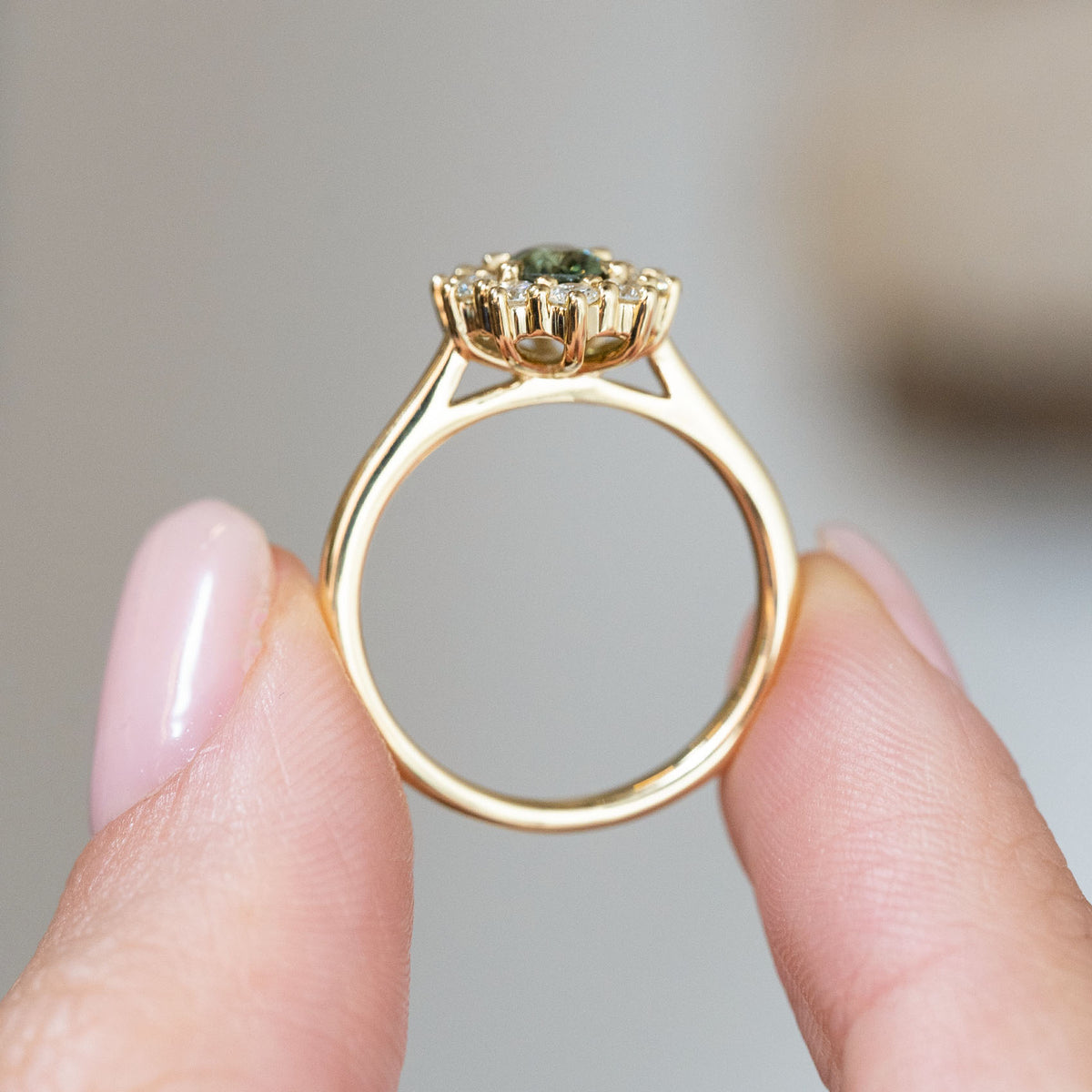 Rear profile showcasing the open yellow gold gallery, elevated gemstone setting and finely tapered shank.