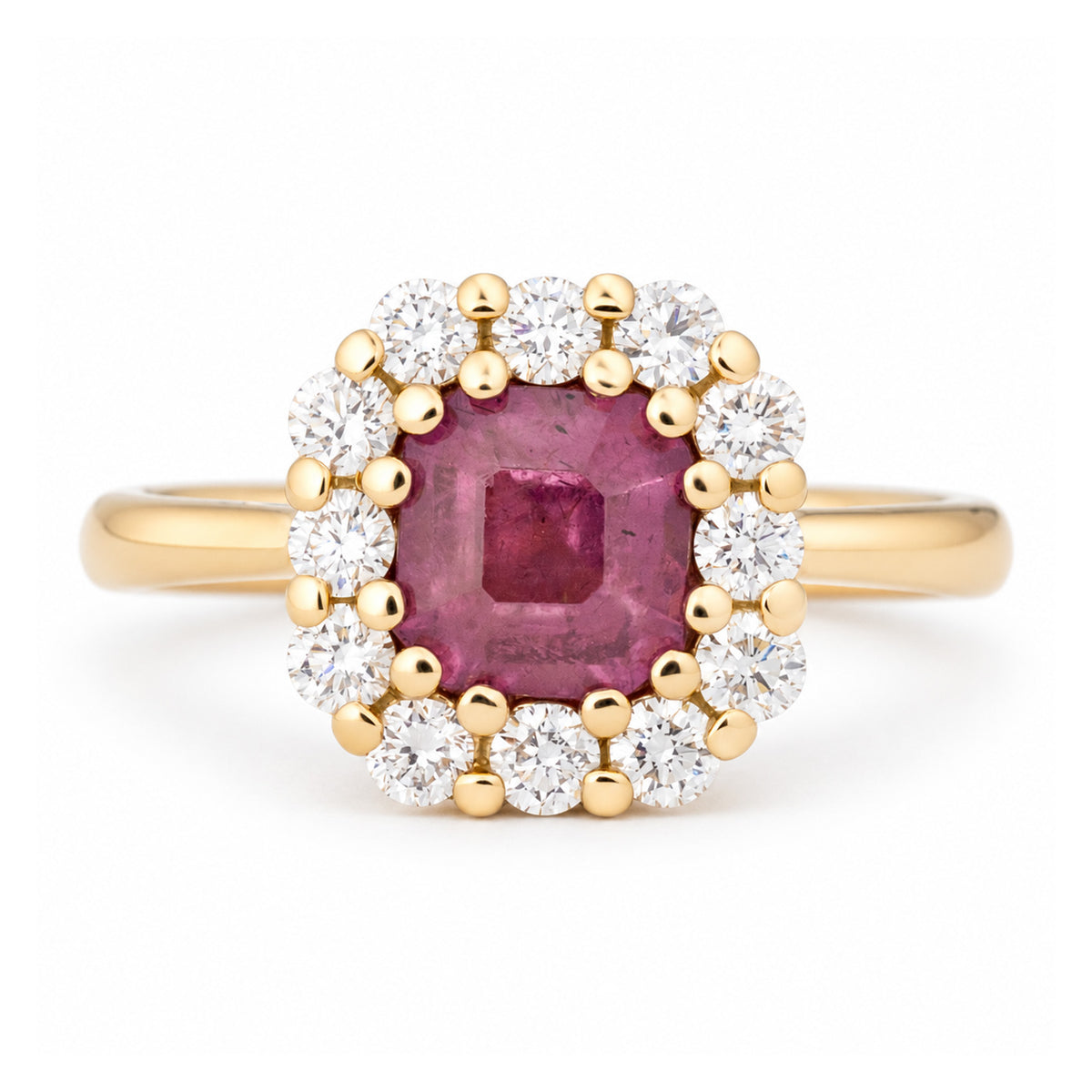 Antique-inspired step-cut pink sapphire and diamond cluster engagement ring in yellow gold, surrounded by a halo of brilliant-cut white diamonds.